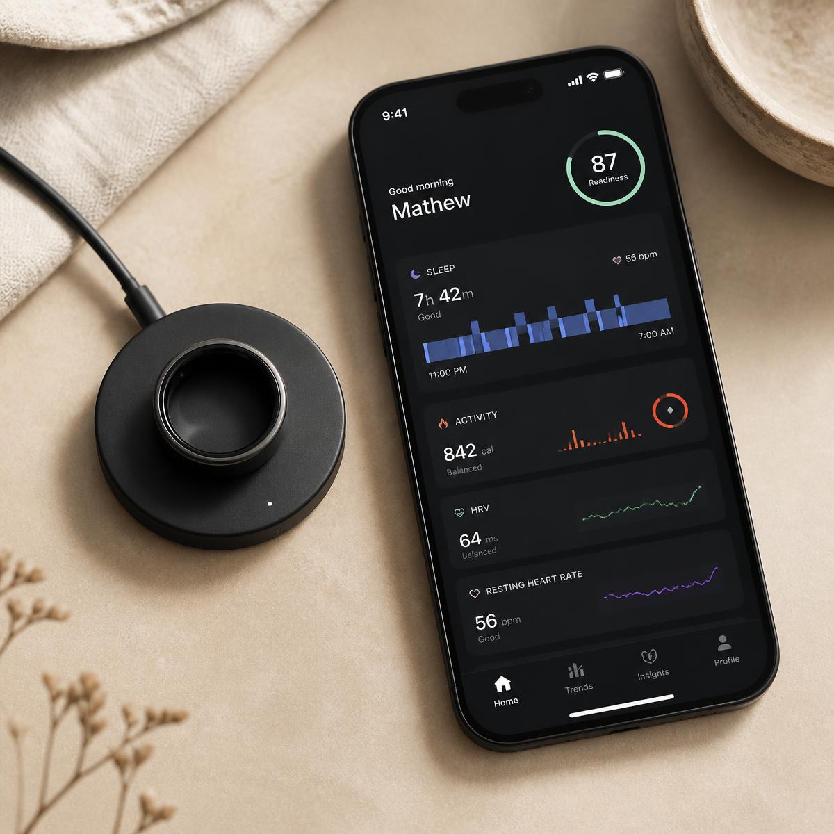 Kiro KR1 on its magnetic charging dock beside the companion app dashboard
